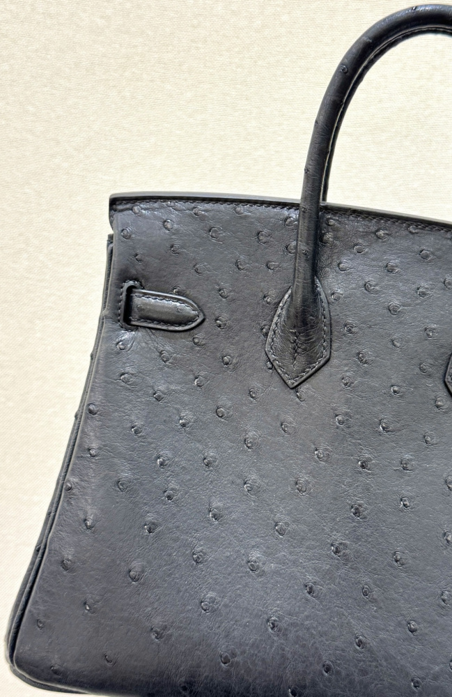 The Hermès Birkin 30 handbag in ostrich leather—featuring the classic black hue paired with gold hardware—is recognized by the brand as one of its "kings of value retention" among exotic skins.
