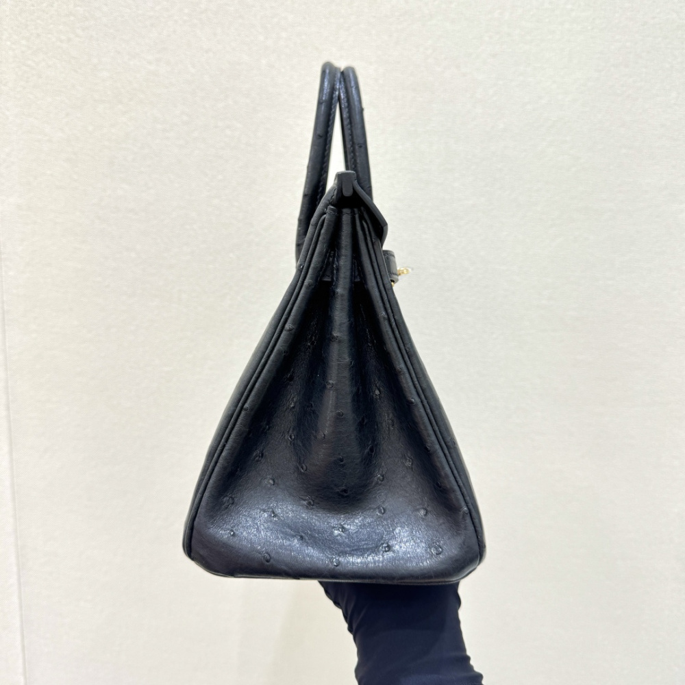 The Hermès Birkin 30 handbag in ostrich leather—featuring the classic black hue paired with gold hardware—is recognized by the brand as one of its "kings of value retention" among exotic skins.