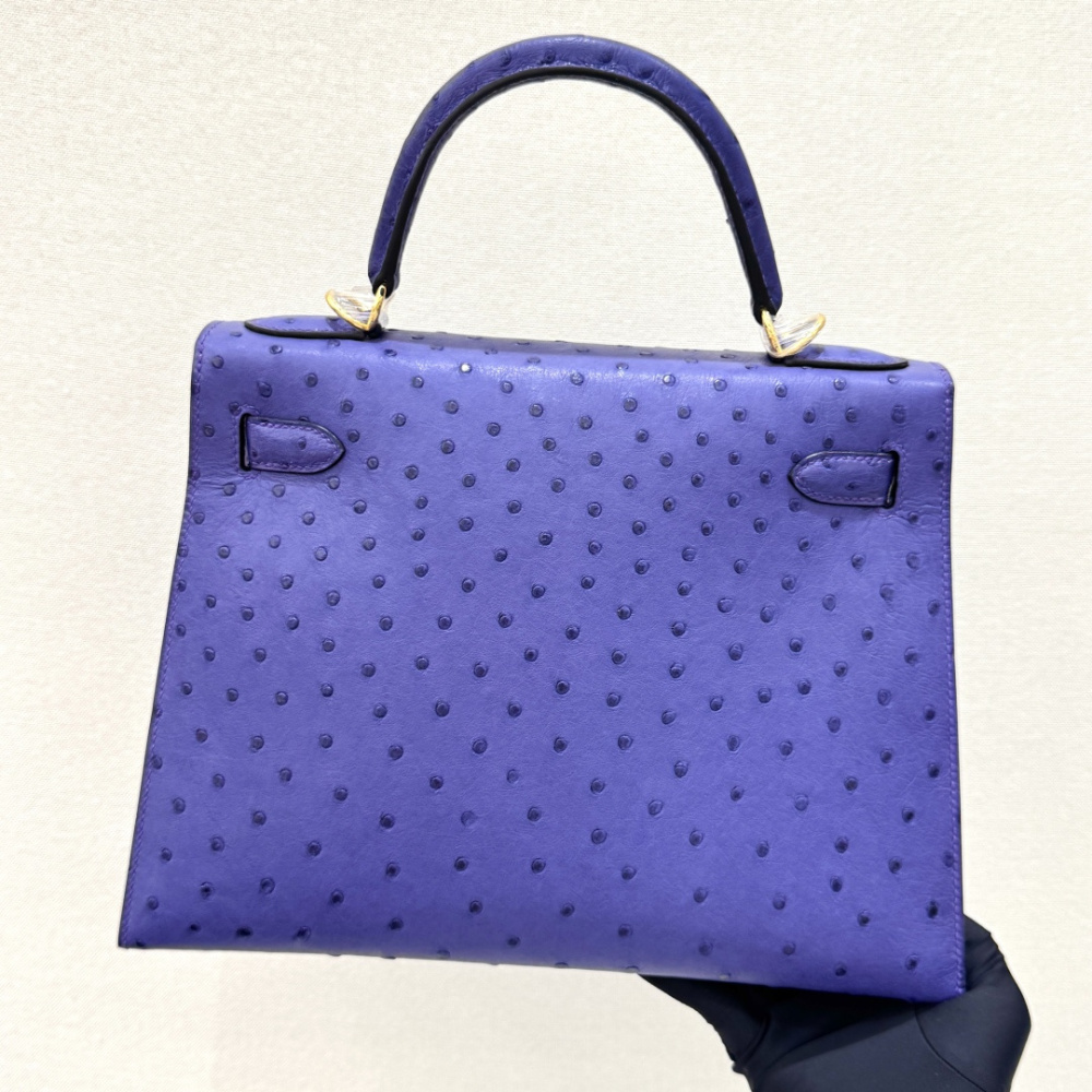 The Hermès Mini Kelly II handbag in ostrich leather—featuring a striking shade of purple (Iris/Electric Purple) paired with gold hardware—stands out as a highly distinctive and exclusive piece among Hermès' rare-skin offerings.