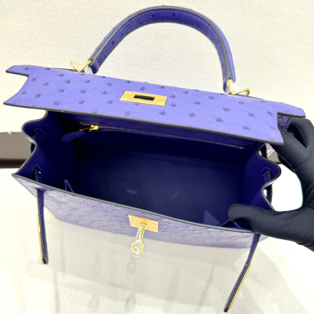 The Hermès Mini Kelly II handbag in ostrich leather—featuring a striking shade of purple (Iris/Electric Purple) paired with gold hardware—stands out as a highly distinctive and exclusive piece among Hermès' rare-skin offerings.