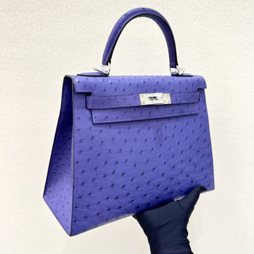 The Hermès Mini Kelly II handbag in ostrich leather—featuring a striking shade of purple (Iris/Electric Purple) paired with gold hardware—stands out as a highly distinctive and exclusive piece among Hermès' rare-skin offerings.