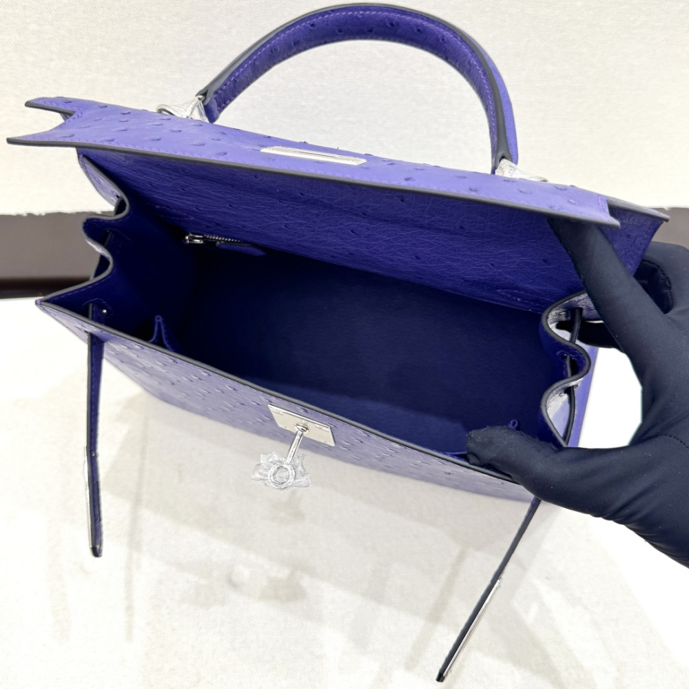 The Hermès Mini Kelly II handbag in ostrich leather—featuring a striking shade of purple (Iris/Electric Purple) paired with gold hardware—stands out as a highly distinctive and exclusive piece among Hermès' rare-skin offerings.