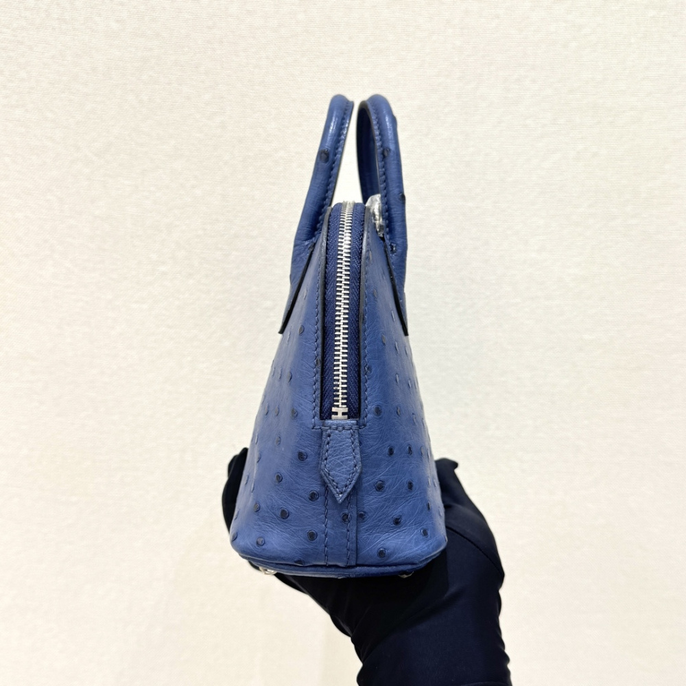 The Hermès Mini Bolide handbag in ostrich leather—featuring a "Haze Blue" (Sailor Blue / Atlantic Blue) hue paired with silver hardware—is a fresh, practical, and highly sought-after piece within the brand's rare skins collection.