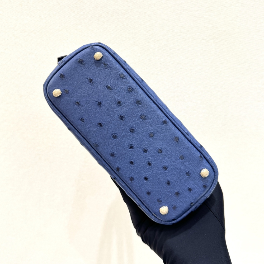 The Hermès Mini Bolide handbag in ostrich leather—featuring a "Haze Blue" (Sailor Blue / Atlantic Blue) hue paired with silver hardware—is a fresh, practical, and highly sought-after piece within the brand's rare skins collection.
