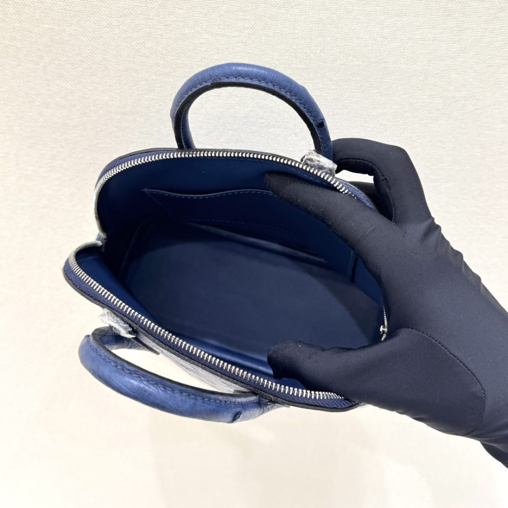 The Hermès Mini Bolide handbag in ostrich leather—featuring a "Haze Blue" (Sailor Blue / Atlantic Blue) hue paired with silver hardware—is a fresh, practical, and highly sought-after piece within the brand's rare skins collection.