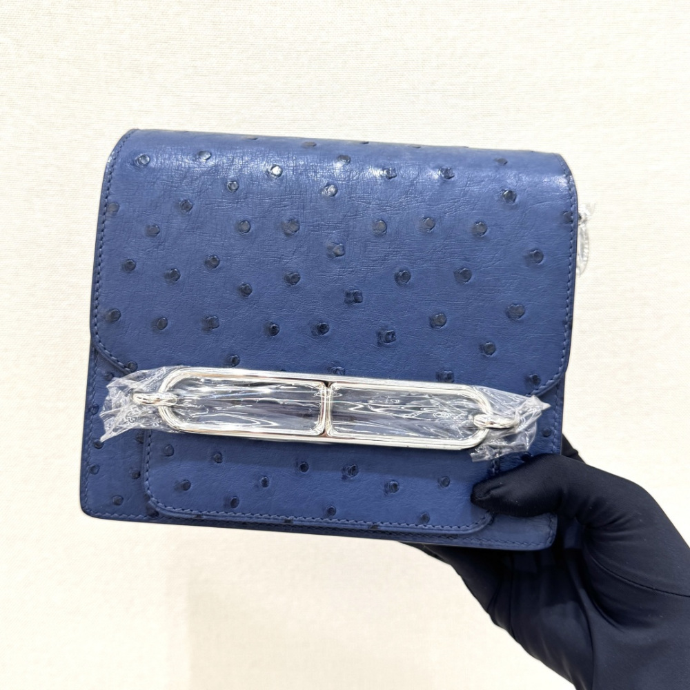 The Hermès Roulis 19 (the "Pig-Nose" bag) in Ostrich leather—featuring a sophisticated Haze Blue (or Sailor Blue) hue paired with silver hardware—stands as a quintessential example of understated luxury within Hermès' rare leather collection.