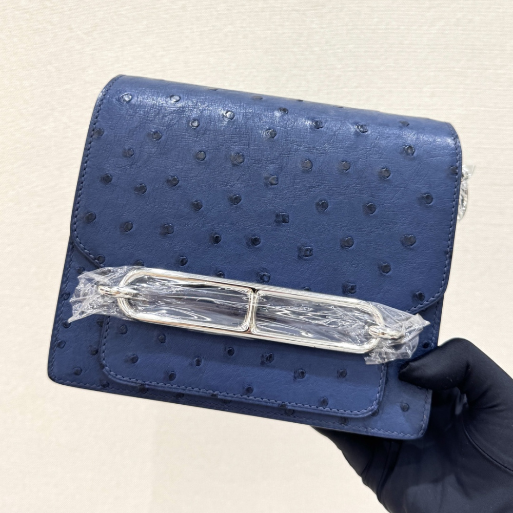 The Hermès Roulis 19 (the "Pig-Nose" bag) in Ostrich leather—featuring a sophisticated Haze Blue (or Sailor Blue) hue paired with silver hardware—stands as a quintessential example of understated luxury within Hermès' rare leather collection.