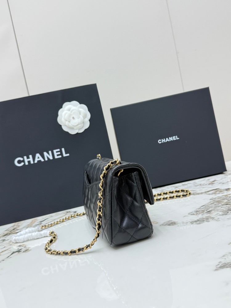 This is a small Chanel Classic Flap bag with a pearl crush charm (often referred to as the "Golden Ball CF") from Chanel, featuring the brand's iconic lambskin and diamond-quilted pattern.