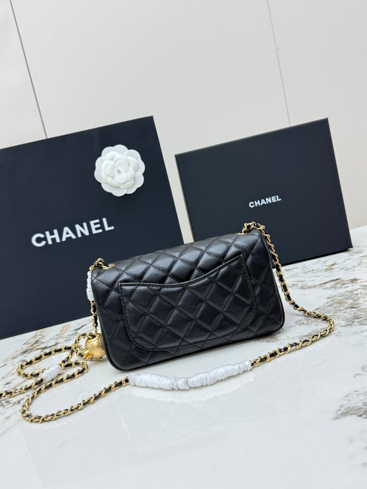 This is a small Chanel Classic Flap bag with a pearl crush charm (often referred to as the "Golden Ball CF") from Chanel, featuring the brand's iconic lambskin and diamond-quilted pattern.