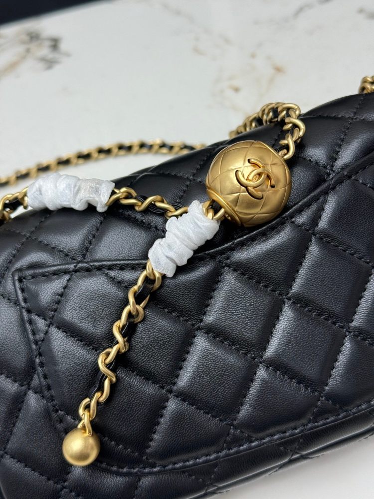 This is a small Chanel Classic Flap bag with a pearl crush charm (often referred to as the "Golden Ball CF") from Chanel, featuring the brand's iconic lambskin and diamond-quilted pattern.