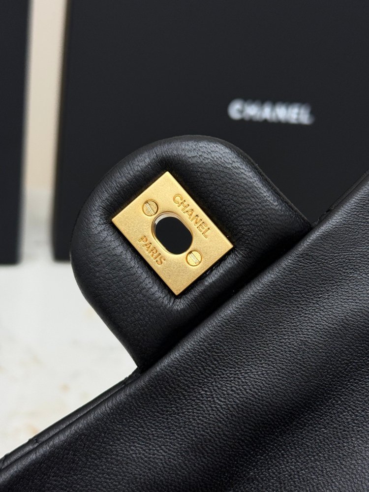 This is a small Chanel Classic Flap bag with a pearl crush charm (often referred to as the "Golden Ball CF") from Chanel, featuring the brand's iconic lambskin and diamond-quilted pattern.