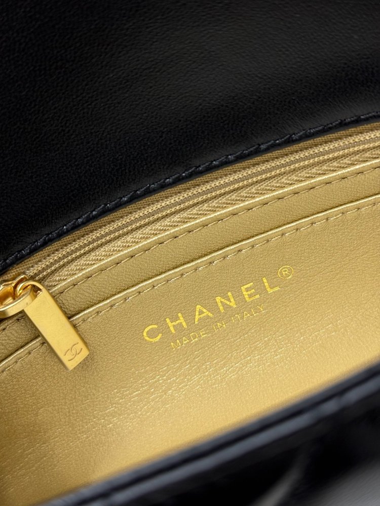 This is a small Chanel Classic Flap bag with a pearl crush charm (often referred to as the "Golden Ball CF") from Chanel, featuring the brand's iconic lambskin and diamond-quilted pattern.