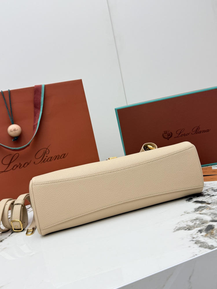 Loro Piana Extra Pocket L19 handbag, crafted in milk tea beige grained leather with gold-tone hardware.
