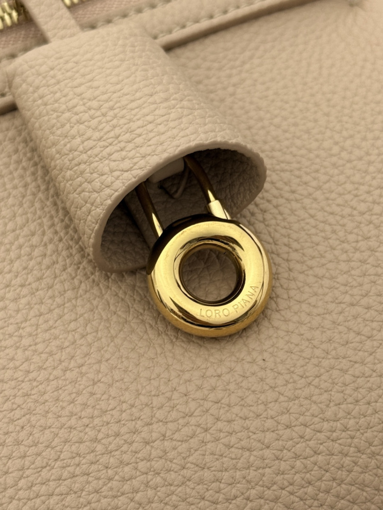 Loro Piana Extra Pocket L19 handbag, crafted in milk tea beige grained leather with gold-tone hardware.