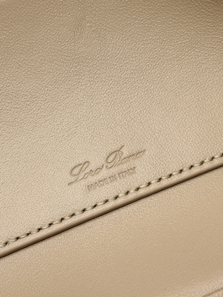 Loro Piana Extra Pocket L19 handbag, crafted in milk tea beige grained leather with gold-tone hardware.
