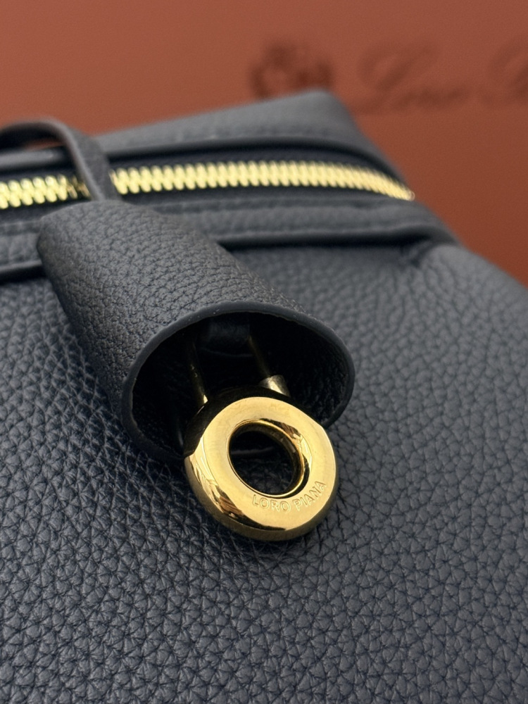 Loro Piana Extra Pocket L19 handbag, crafted in black grained leather with gold-tone hardware.