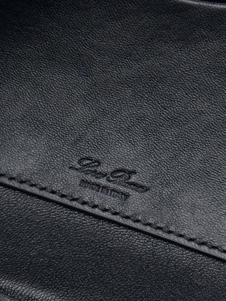 Loro Piana Extra Pocket L19 handbag, crafted in black grained leather with gold-tone hardware.