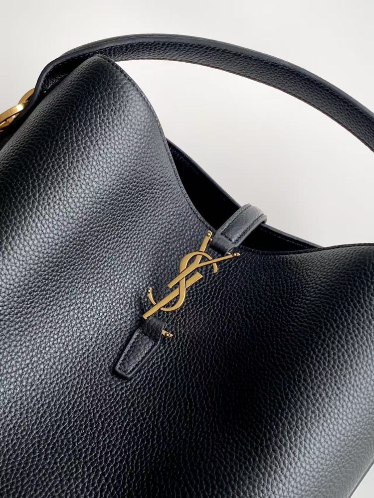 This is a bucket bag from Yves Saint Laurent (YSL), crafted in black grained leather with a gold-tone YSL logo hardware. It comes with a detachable pouch and strap, suitable for both hand-held and crossbody wear.