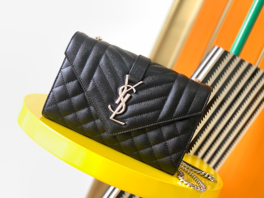 This is a classic Yves Saint Laurent shoulder bag, crafted from black caviar-textured leather and adorned on the front with striking gold-tone hardware featuring the iconic YSL logo.