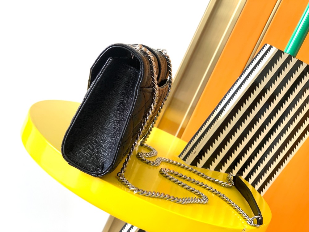 This is a classic Yves Saint Laurent shoulder bag, crafted from black caviar-textured leather and adorned on the front with striking gold-tone hardware featuring the iconic YSL logo.