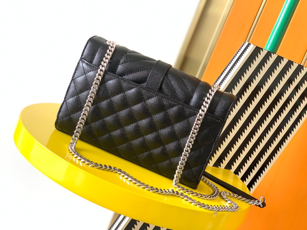 This is a classic Yves Saint Laurent shoulder bag, crafted from black caviar-textured leather and adorned on the front with striking gold-tone hardware featuring the iconic YSL logo.