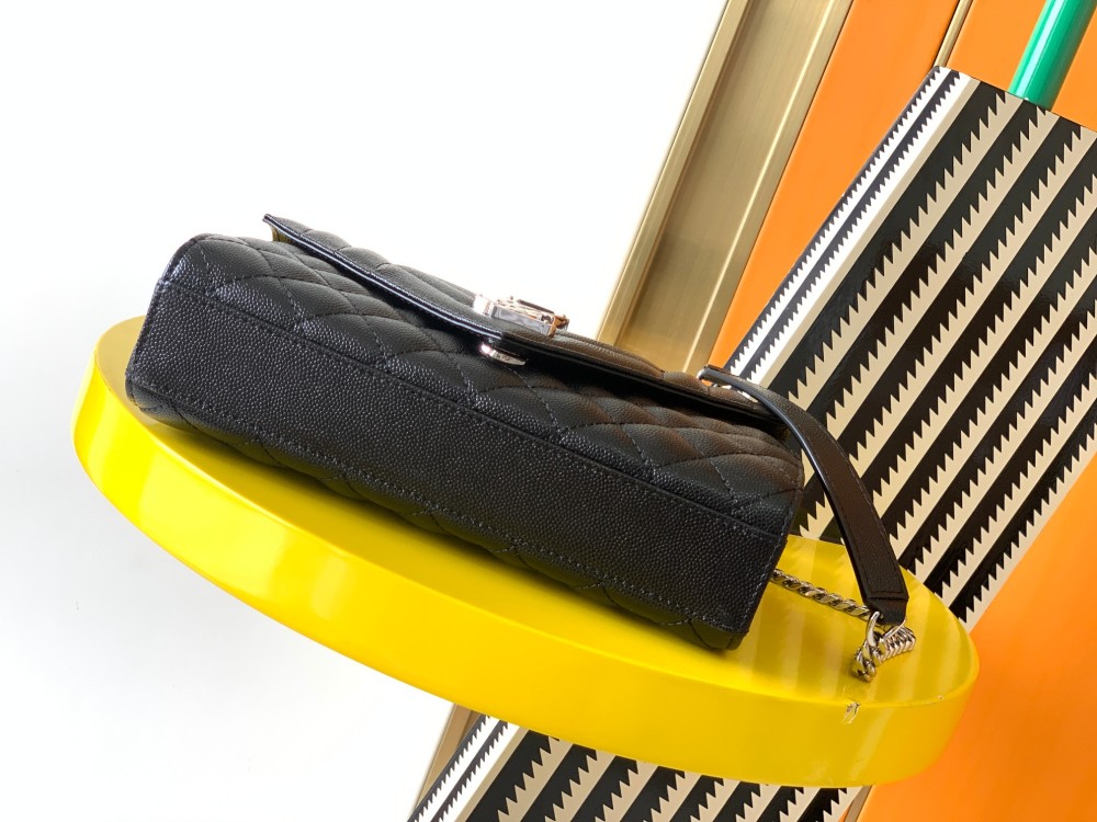 This is a classic Yves Saint Laurent shoulder bag, crafted from black caviar-textured leather and adorned on the front with striking gold-tone hardware featuring the iconic YSL logo.