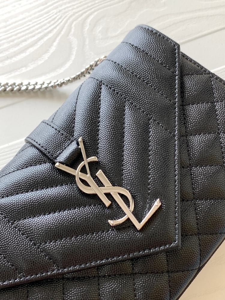 This is a classic Yves Saint Laurent shoulder bag, crafted from black caviar-textured leather and adorned on the front with striking gold-tone hardware featuring the iconic YSL logo.