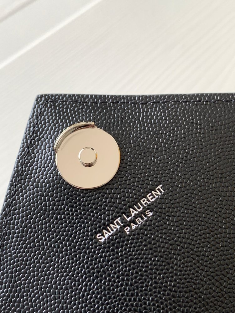 This is a classic Yves Saint Laurent shoulder bag, crafted from black caviar-textured leather and adorned on the front with striking gold-tone hardware featuring the iconic YSL logo.