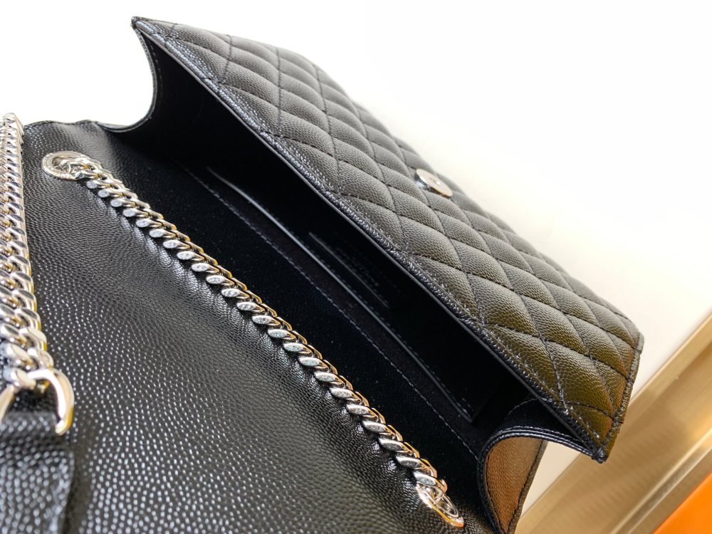 This is a classic Yves Saint Laurent shoulder bag, crafted from black caviar-textured leather and adorned on the front with striking gold-tone hardware featuring the iconic YSL logo.