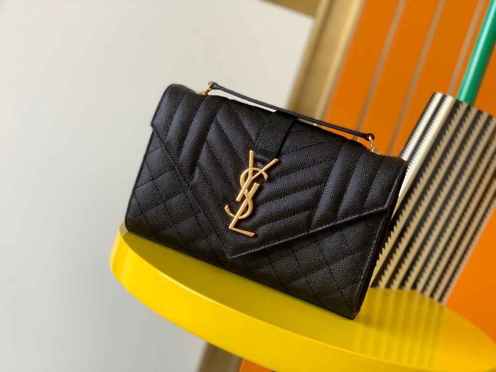 This is a quilted envelope bag from YSL, crafted in black caviar leather with a gold-tone logo and metal chain strap, suitable for shoulder or crossbody wear.