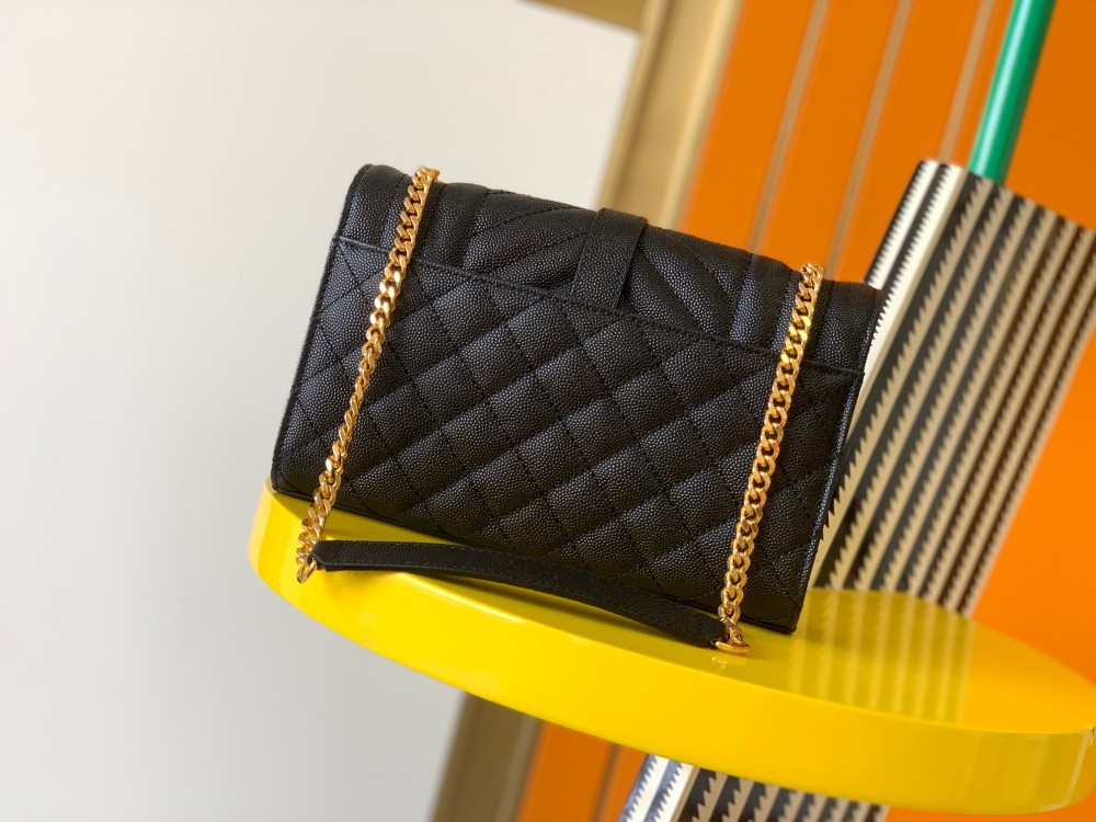 This is a quilted envelope bag from YSL, crafted in black caviar leather with a gold-tone logo and metal chain strap, suitable for shoulder or crossbody wear.