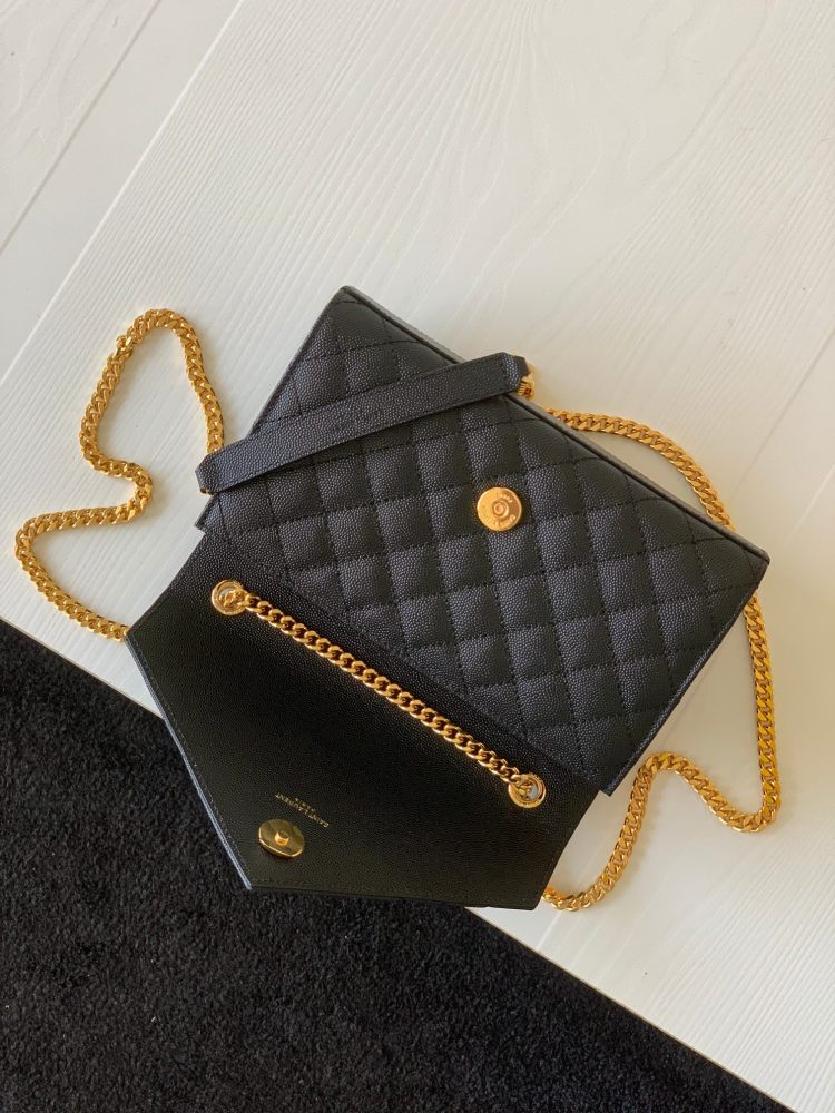 This is a quilted envelope bag from YSL, crafted in black caviar leather with a gold-tone logo and metal chain strap, suitable for shoulder or crossbody wear.