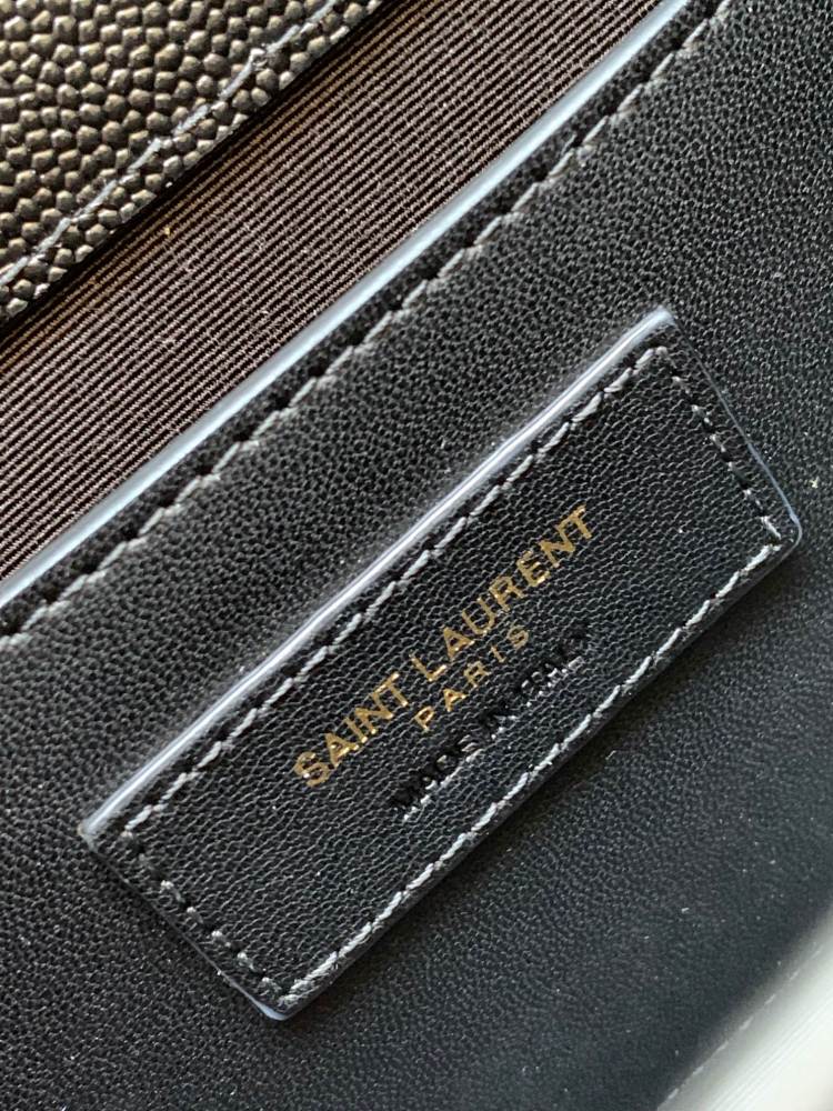This is a quilted envelope bag from YSL, crafted in black caviar leather with a gold-tone logo and metal chain strap, suitable for shoulder or crossbody wear.