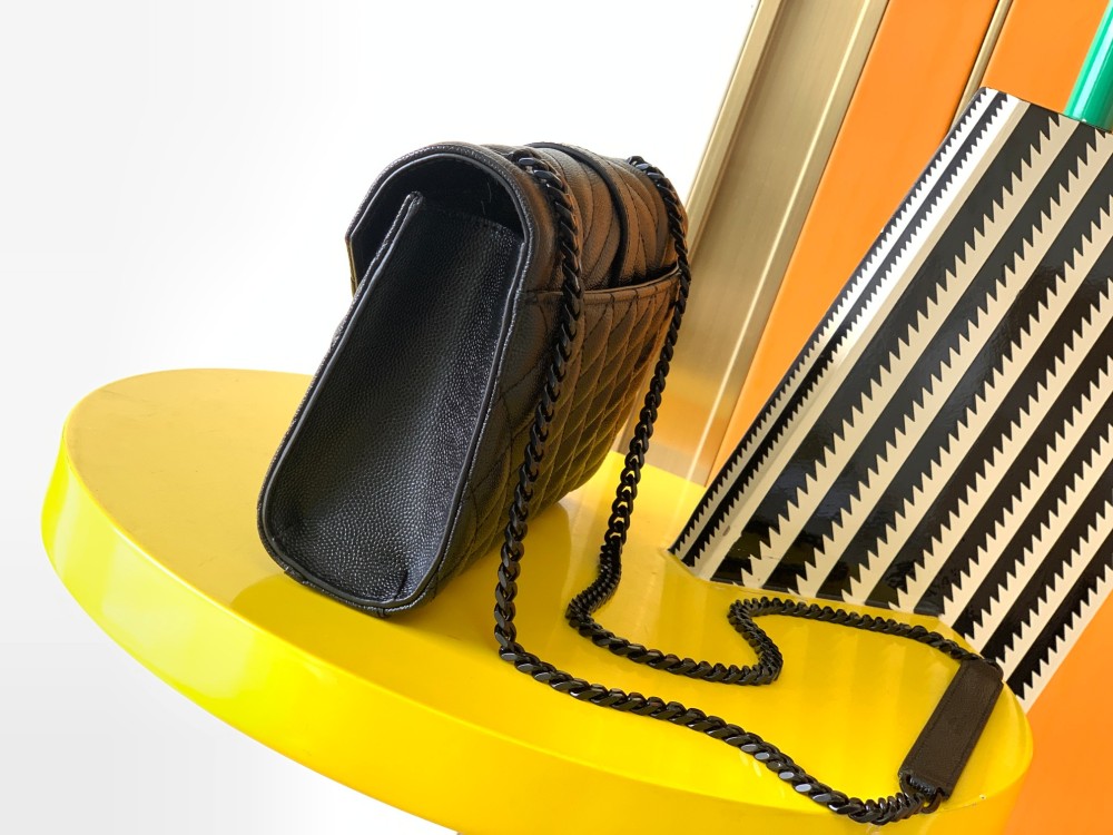 This is a quilted envelope bag from YSL, crafted in black caviar leather with a matching black logo and metal chain strap, suitable for shoulder or crossbody wear.