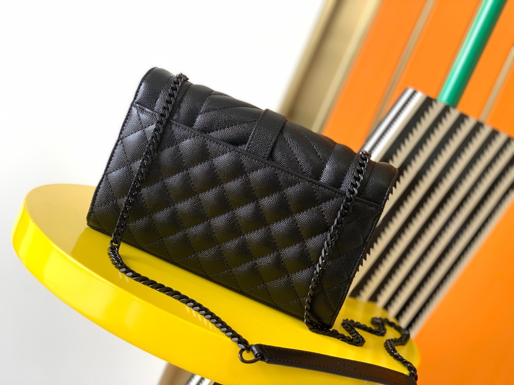 This is a quilted envelope bag from YSL, crafted in black caviar leather with a matching black logo and metal chain strap, suitable for shoulder or crossbody wear.