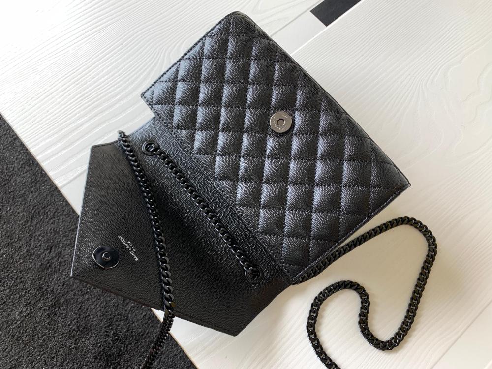 This is a quilted envelope bag from YSL, crafted in black caviar leather with a matching black logo and metal chain strap, suitable for shoulder or crossbody wear.