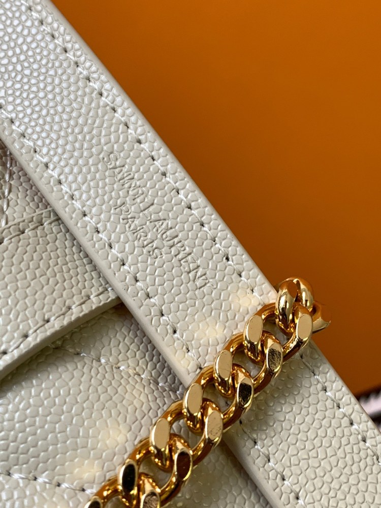 This is a quilted envelope bag from YSL, crafted in off-white caviar leather with a gold-tone logo and metal chain strap, suitable for shoulder or crossbody wear.