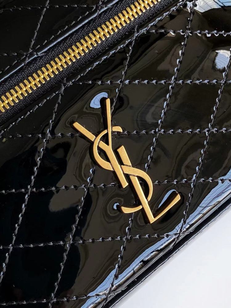 This is a quilted cosmetic bag from YSL, crafted in black patent leather with a gold-tone logo and detachable strap, suitable for hand-held or shoulder wear.