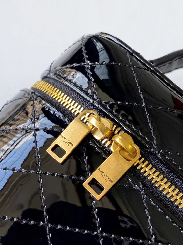 This is a quilted cosmetic bag from YSL, crafted in black patent leather with a gold-tone logo and detachable strap, suitable for hand-held or shoulder wear.