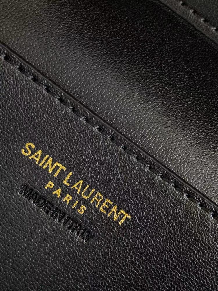 This is a quilted cosmetic bag from YSL, crafted in black patent leather with a gold-tone logo and detachable strap, suitable for hand-held or shoulder wear.