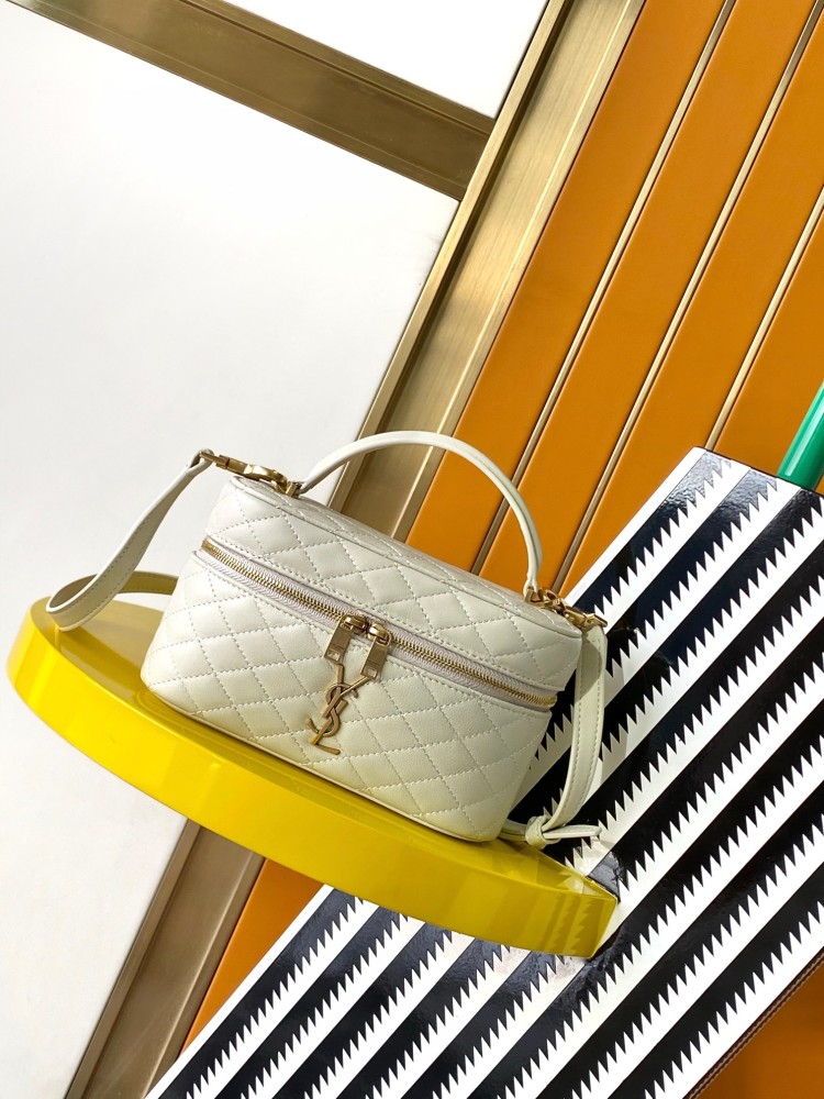 This is a quilted cosmetic bag from YSL, crafted in off-white grained leather with a gold-tone logo and detachable strap, suitable for hand-held or shoulder wear.