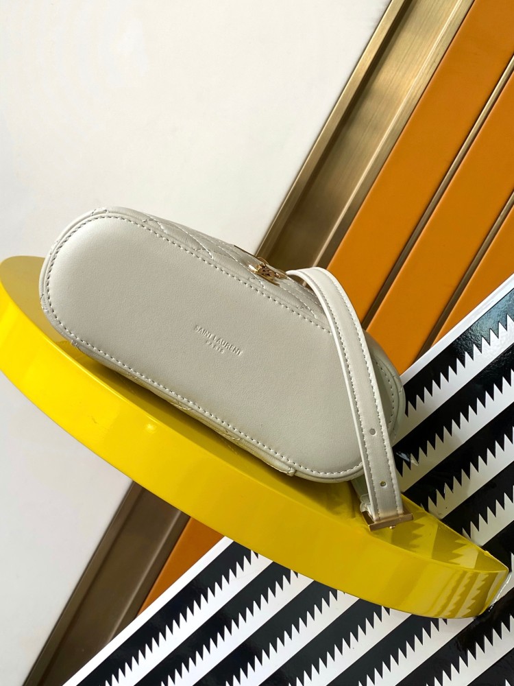 This is a quilted cosmetic bag from YSL, crafted in off-white grained leather with a gold-tone logo and detachable strap, suitable for hand-held or shoulder wear.