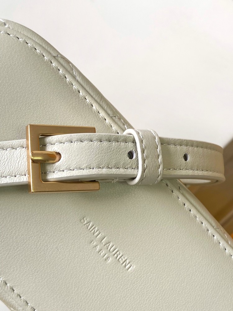 This is a quilted cosmetic bag from YSL, crafted in off-white grained leather with a gold-tone logo and detachable strap, suitable for hand-held or shoulder wear.