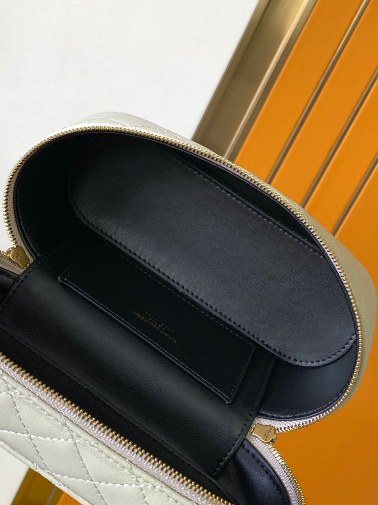 This is a quilted cosmetic bag from YSL, crafted in off-white grained leather with a gold-tone logo and detachable strap, suitable for hand-held or shoulder wear.