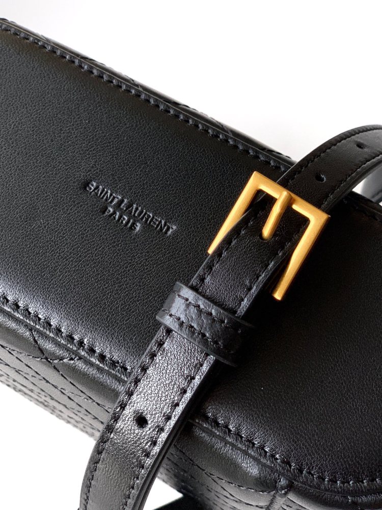 This is a quilted vanity-style handbag from Yves Saint Laurent (YSL), crafted in smooth black leather with a gold-tone brand logo and detachable strap. It exudes an elegant handheld feel and the convenience of shoulder carrying.
