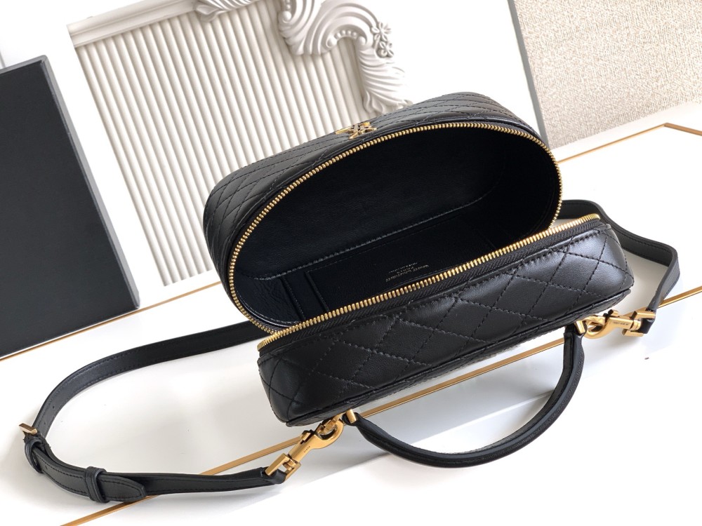 This is a quilted vanity-style handbag from Yves Saint Laurent (YSL), crafted in smooth black leather with a gold-tone brand logo and detachable strap. It exudes an elegant handheld feel and the convenience of shoulder carrying.