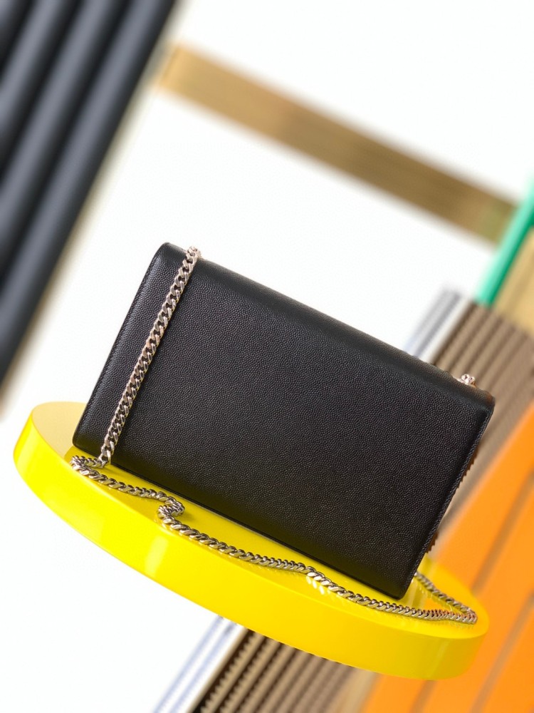 This bag is the classic YSL (Yves Saint Laurent) Kate shoulder bag. It features black caviar leather (pebbled leather) with the iconic silver-tone YSL logo and a silver-tone metal chain.