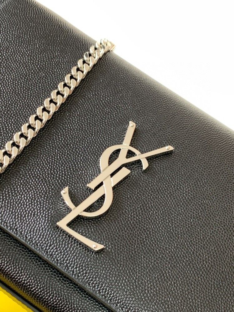 This bag is the classic YSL (Yves Saint Laurent) Kate shoulder bag. It features black caviar leather (pebbled leather) with the iconic silver-tone YSL logo and a silver-tone metal chain.
