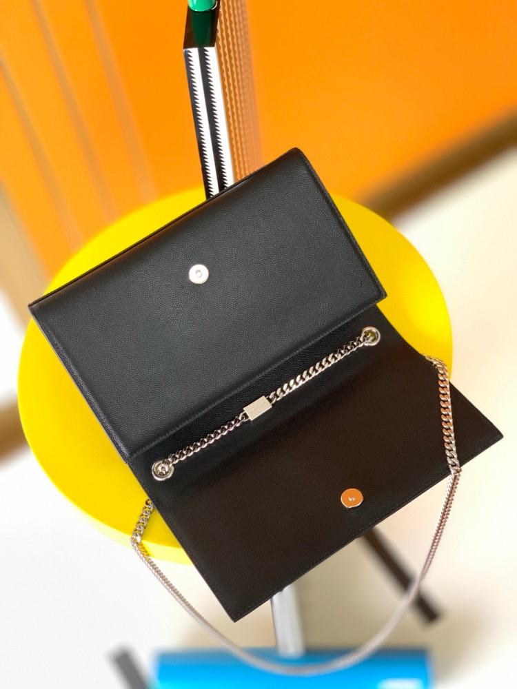 This bag is the classic YSL (Yves Saint Laurent) Kate shoulder bag. It features black caviar leather (pebbled leather) with the iconic silver-tone YSL logo and a silver-tone metal chain.