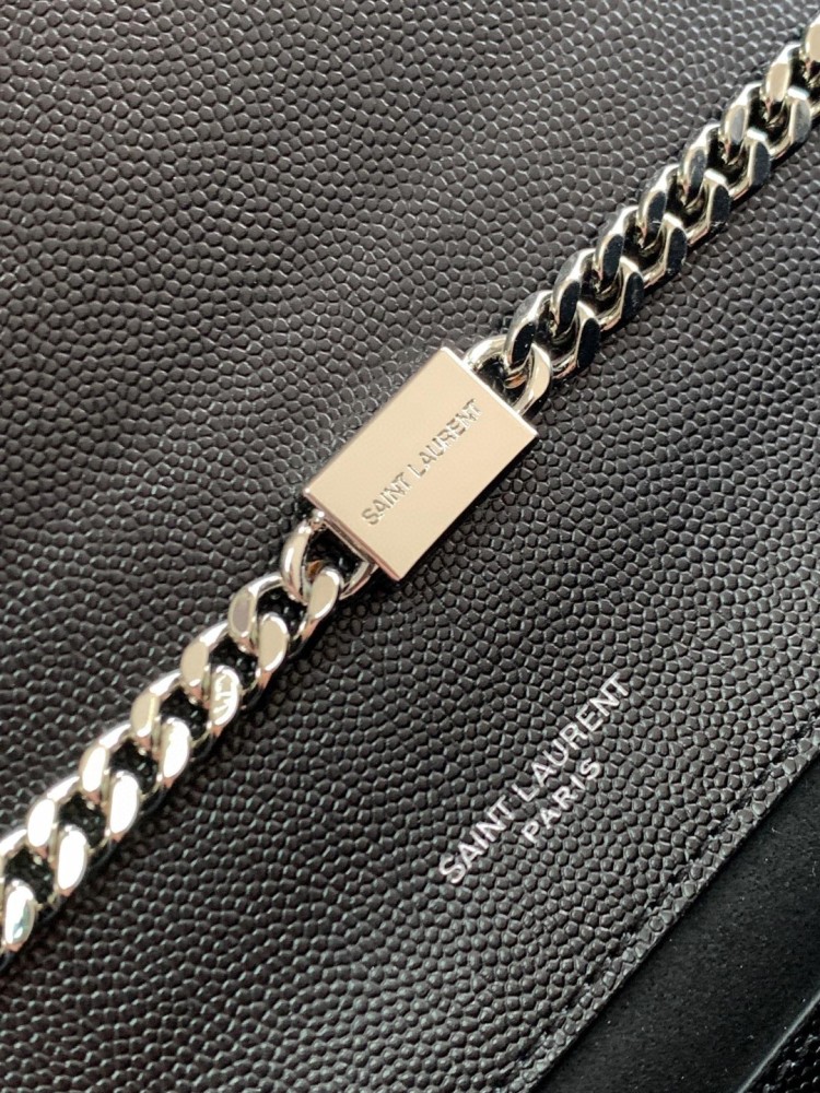 This bag is the classic YSL (Yves Saint Laurent) Kate shoulder bag. It features black caviar leather (pebbled leather) with the iconic silver-tone YSL logo and a silver-tone metal chain.